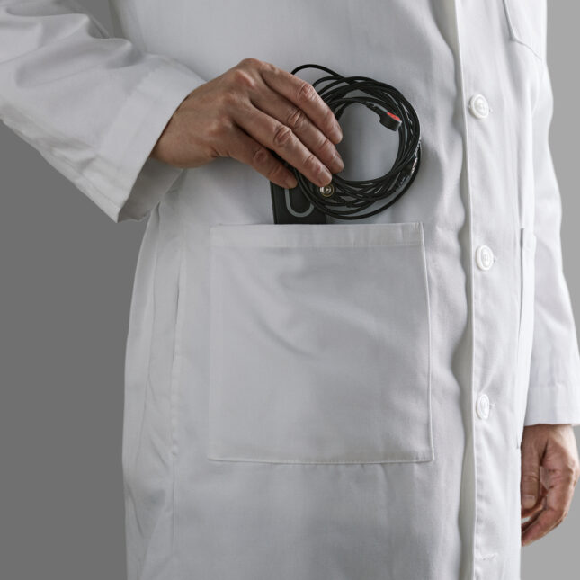 A doctor puts Kardia 12L, a 12-lead electrocardiogram device, into the pocket of a lab coat — health tech coverage from STAT