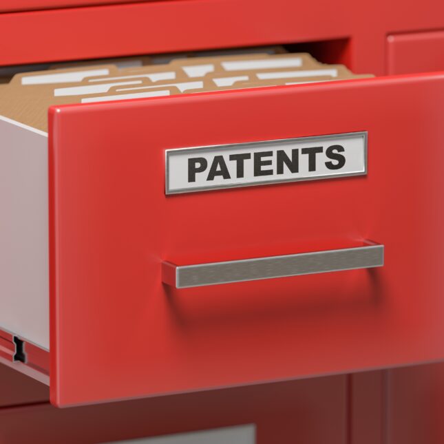 An open drawer labeled "PATENTS" filled with paper files — first opinion coverage from STAT