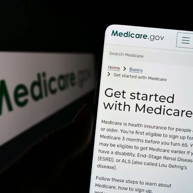 A phone screen displays the webpage of Medicare.gov — coverage from STAT