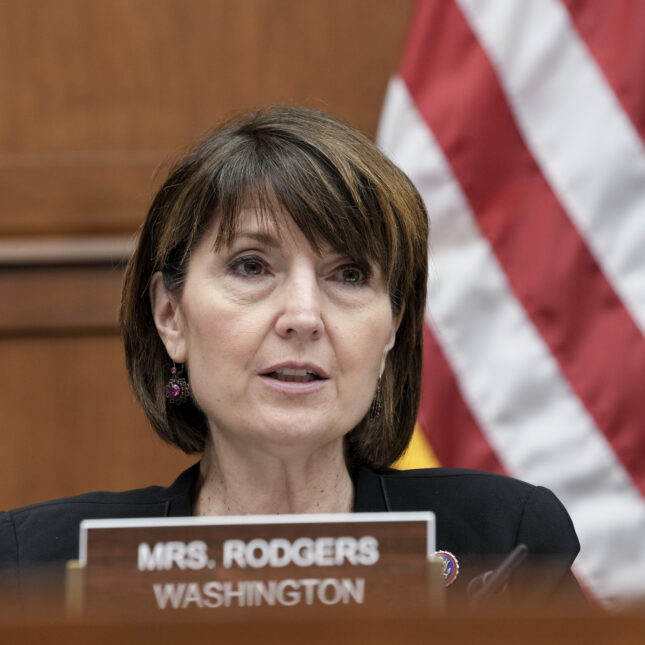 Rep. Cathy McMorris Rodgers speaks at a hearing in front of an American flag and behind her name tag — politics coverage from STAT