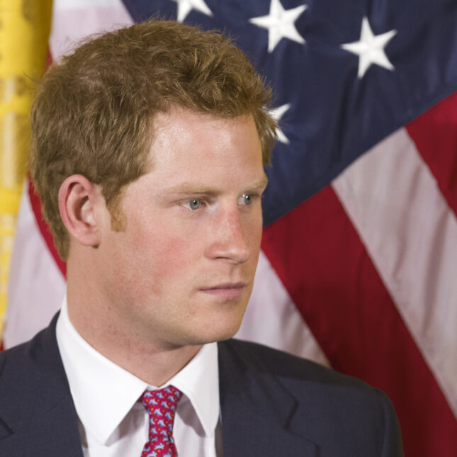 Prince Harry stands in front of the American flag. -- first opinion coverage from STAT