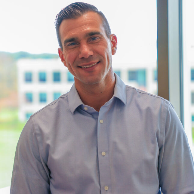 Brian Anderson, a man with short hair, smiles at the camera