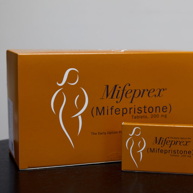 A big box of Mifepristone behind a small package of Mifepristone on a table — politics coverage from STAT