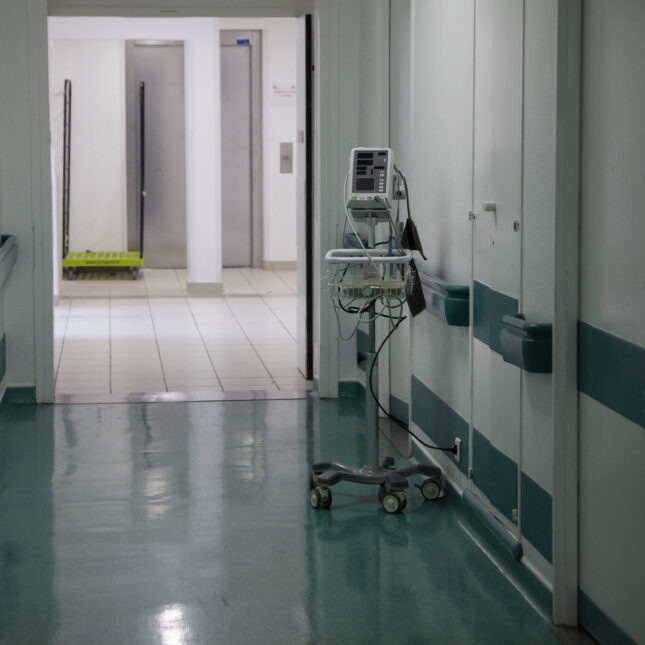 An automatic blood pressure monitor in a clinic hallway. -- chronic disease coverage from STAT