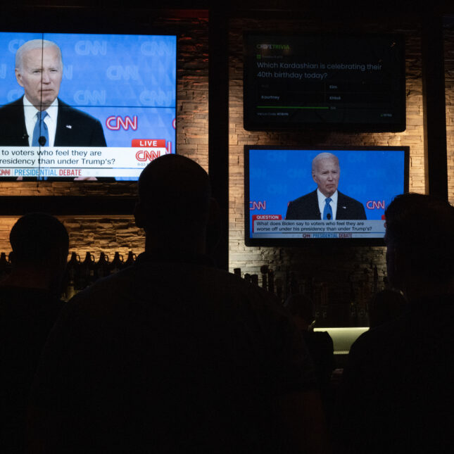 A photograph of Guests at the Old Town Pour House watch the debate between President Joe Biden and presumptive Republican nominee former President Donald Trump on June 27, 2024 in Chicago, Illinois