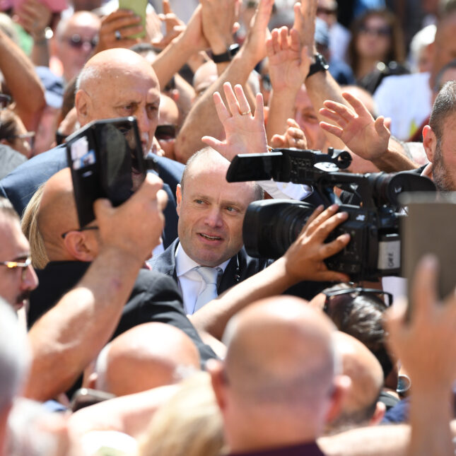 Former prime minister Joseph Muscat makes his way into law courts in Valletta, Malta on May 28, surrounded by supporters. Muscat was charged with with serious crimes over the Vitals hospitals scandal